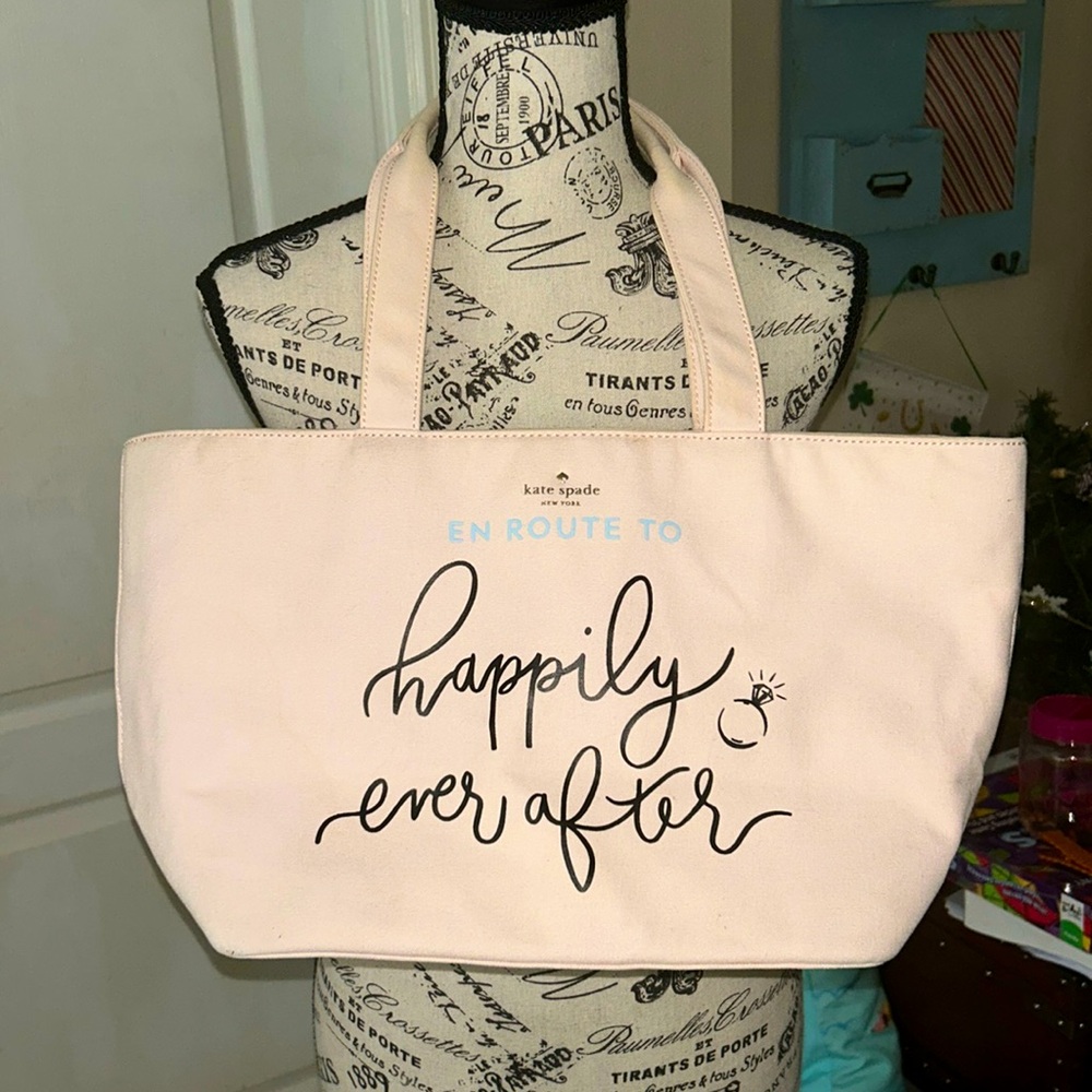 kate spade cream canvas tote with black script and light blue accent